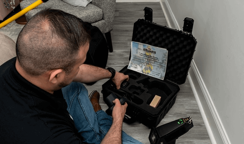 Inspection technician using specialized tools for property assessment.